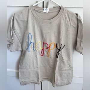 Hand embroidered “happy” t shirt in multicolor letters